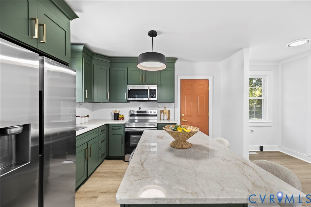 Kitchen featuring green cabinetry, stainless steel appliances, a white tile backsplash, a large island with a stone countertop, and wood-finish flooring