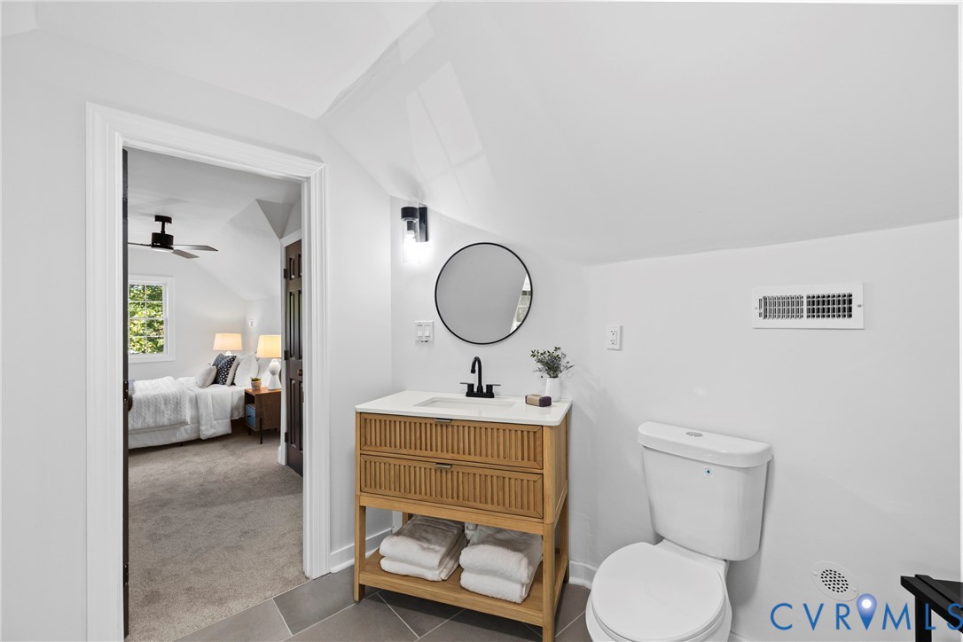 Modern vanity with integrated storage, circular mirror, and wall-mounted lighting