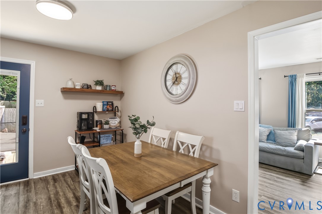 Wood-finish flooring throughout, with a solid door providing exterior access