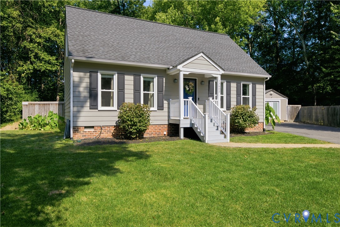 Siding exterior with brick foundation and a gabled porch entry