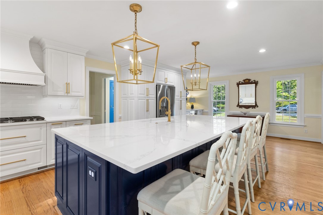Expansive kitchen island featuring a white countertop with a navy blue base