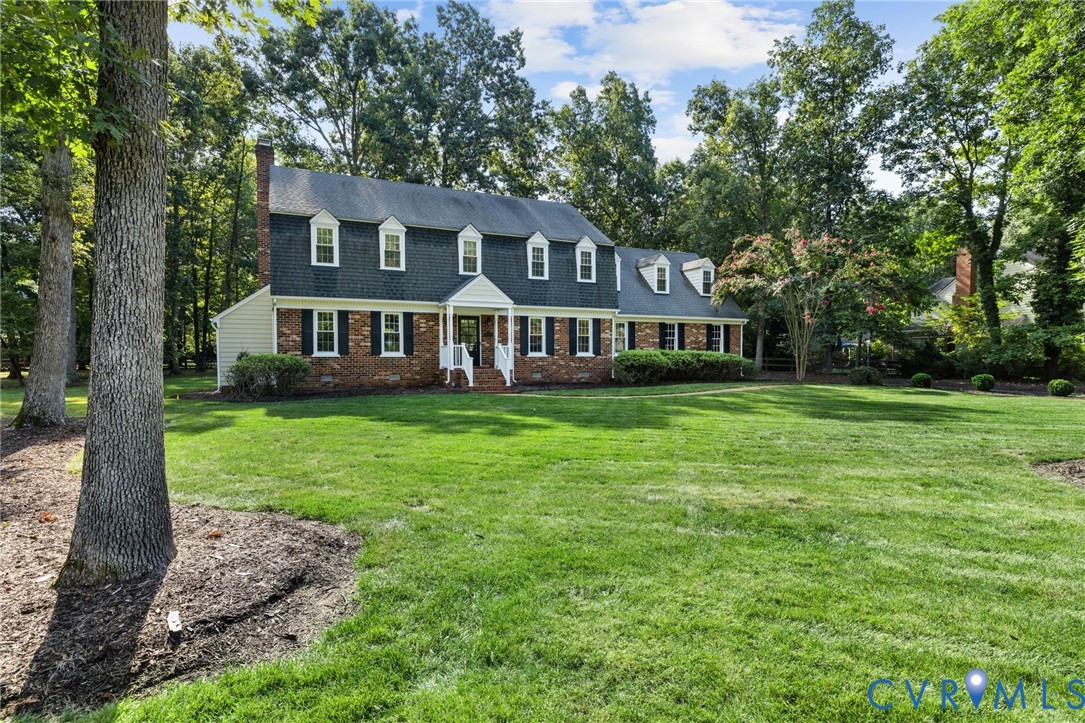 Brick exterior with white siding accents and a dark roof