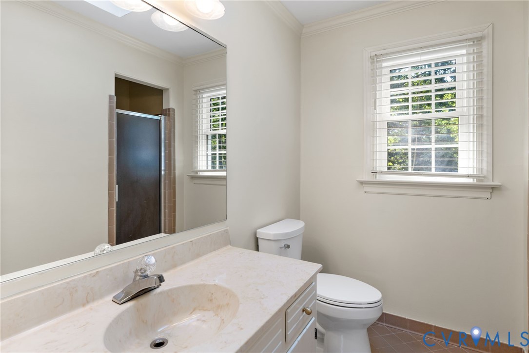 Vanity with integrated sink, full-width mirror, and overhead lighting