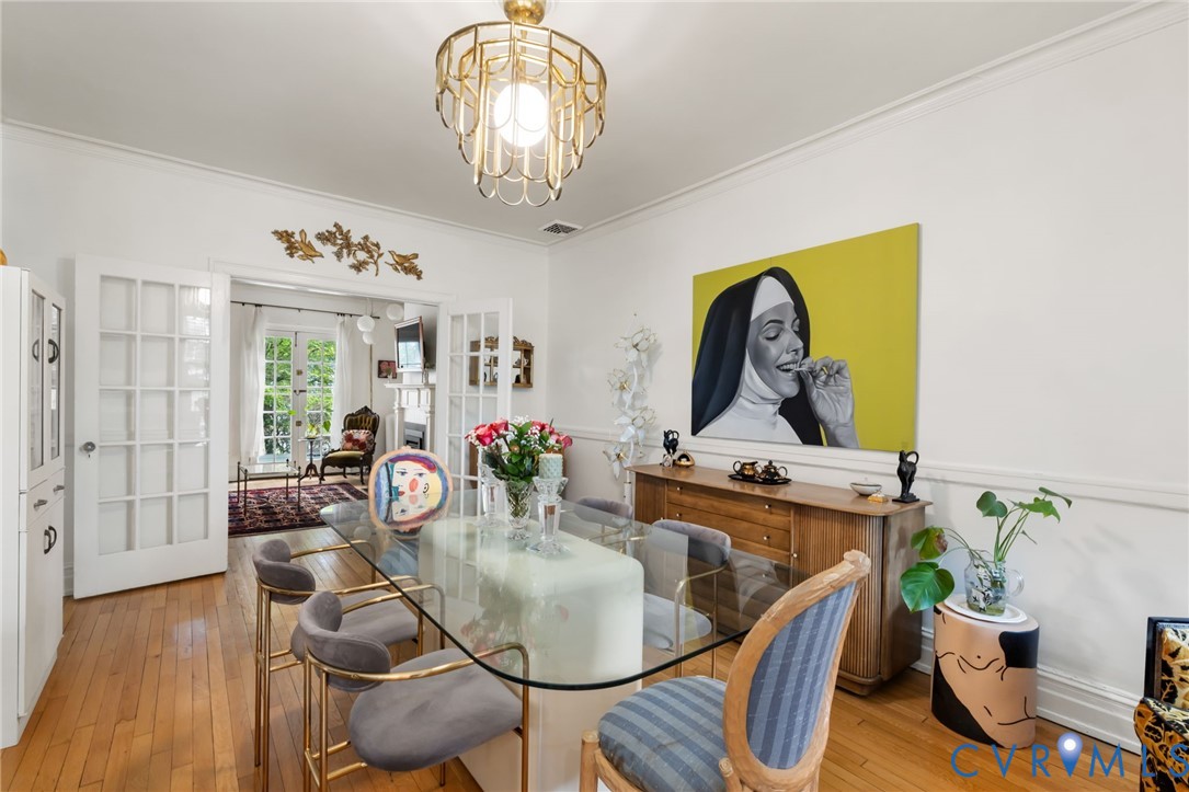 Hardwood flooring, crown molding, and wainscoting details