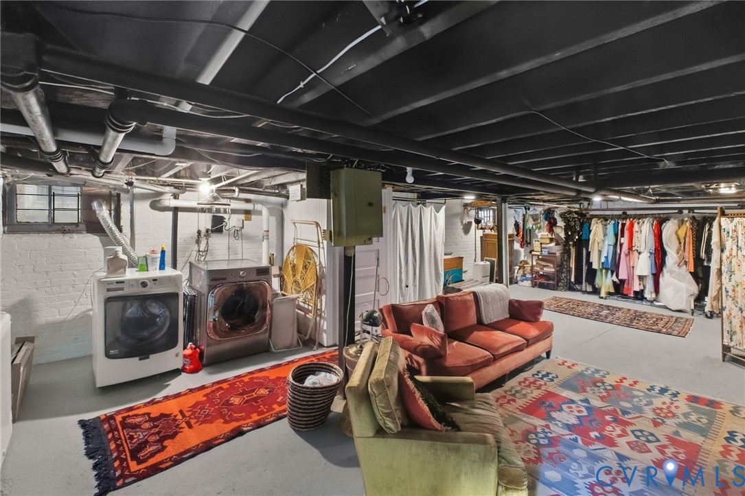 Finished basement area with painted ceiling joists and exposed ductwork