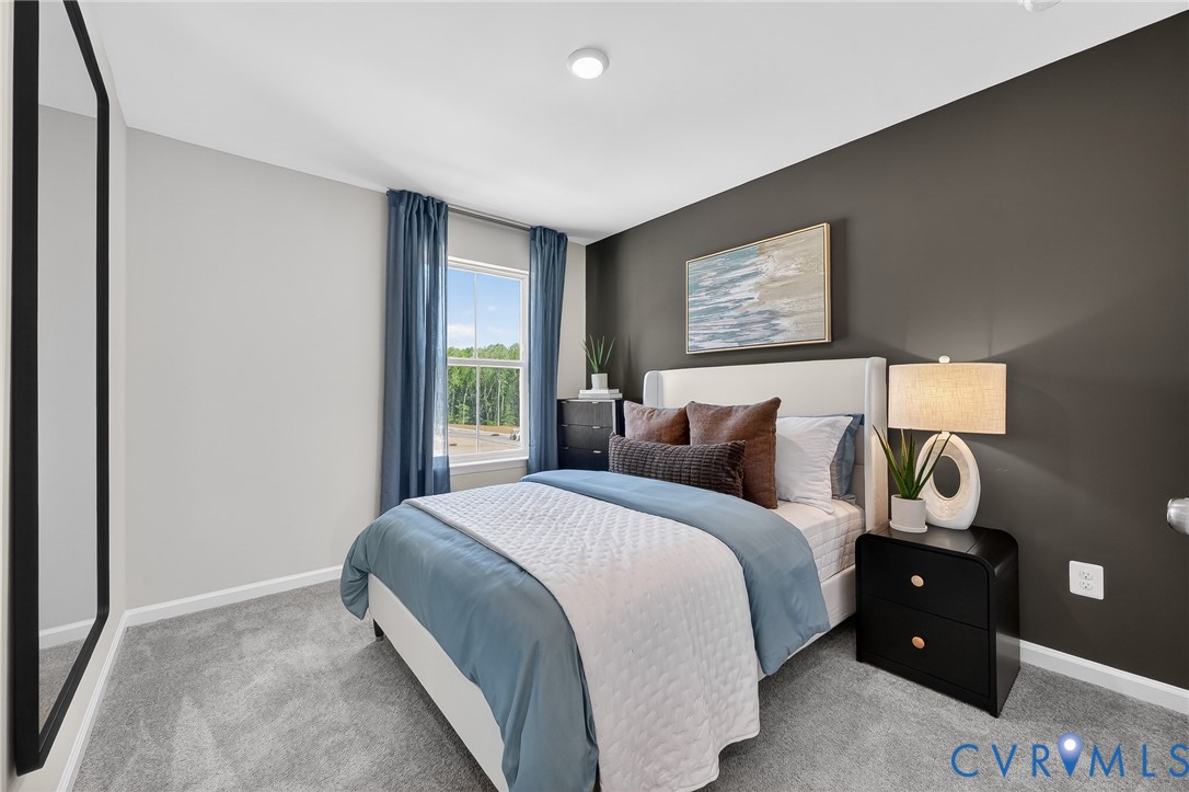 Plush carpeting, a window with exterior scenery, a recessed ceiling light, and a two-tone painted wall
