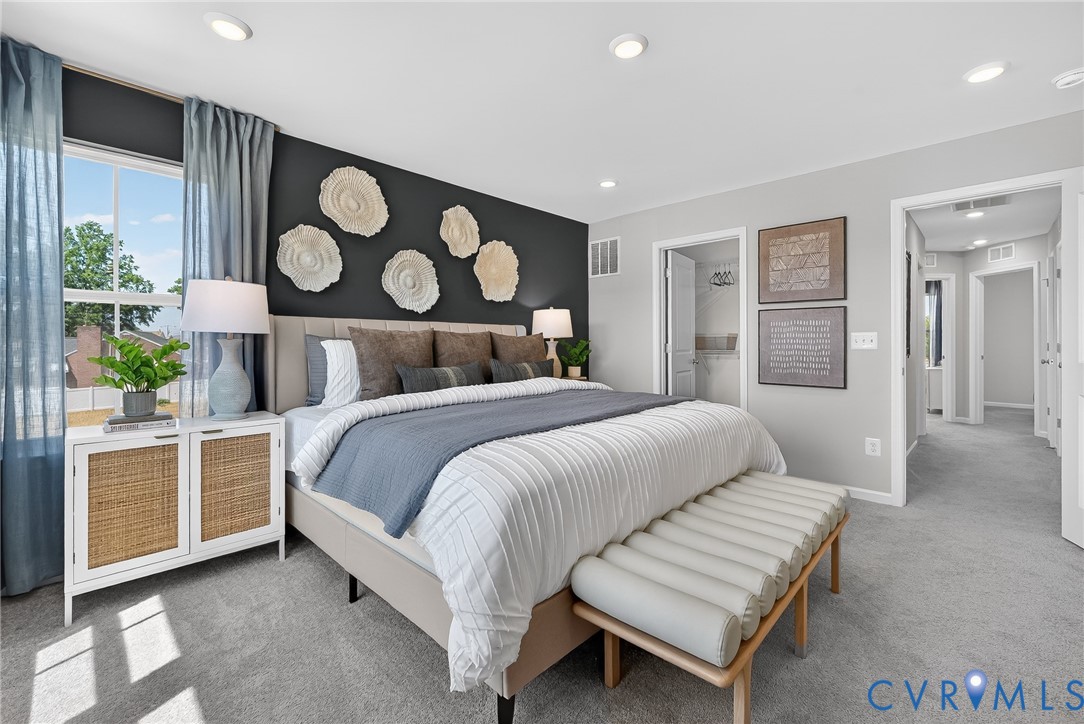 Recessed lighting, soft gray wall paint, and a window with white trim