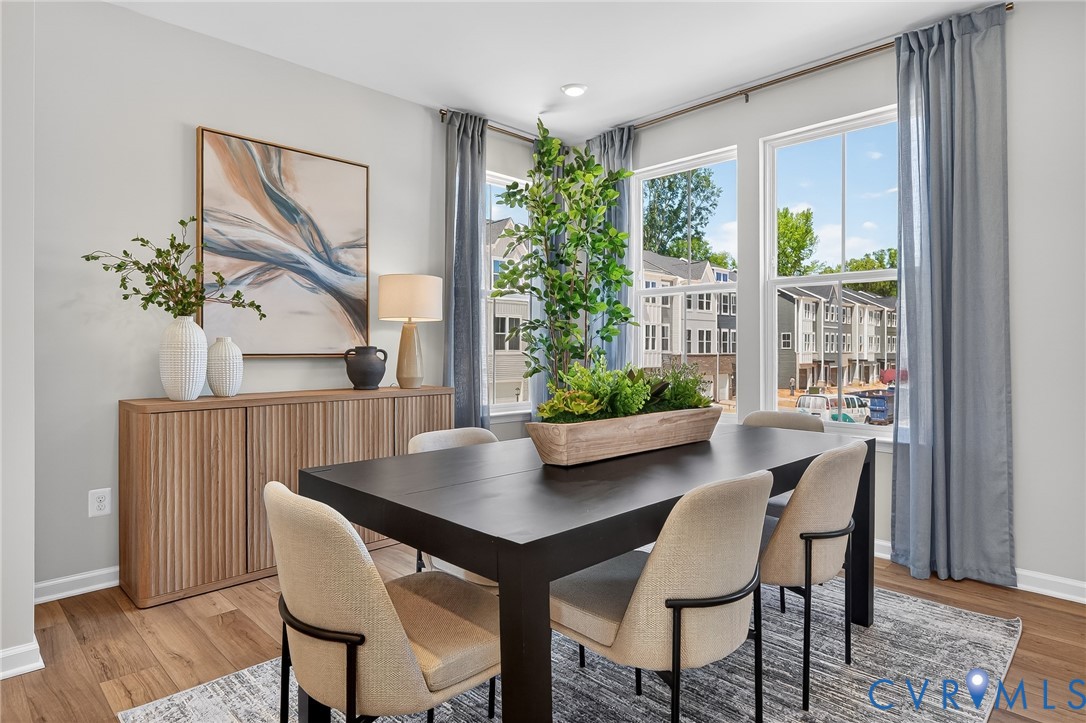 Wood-finish flooring throughout, complemented by a light wood-toned buffet with reeded details