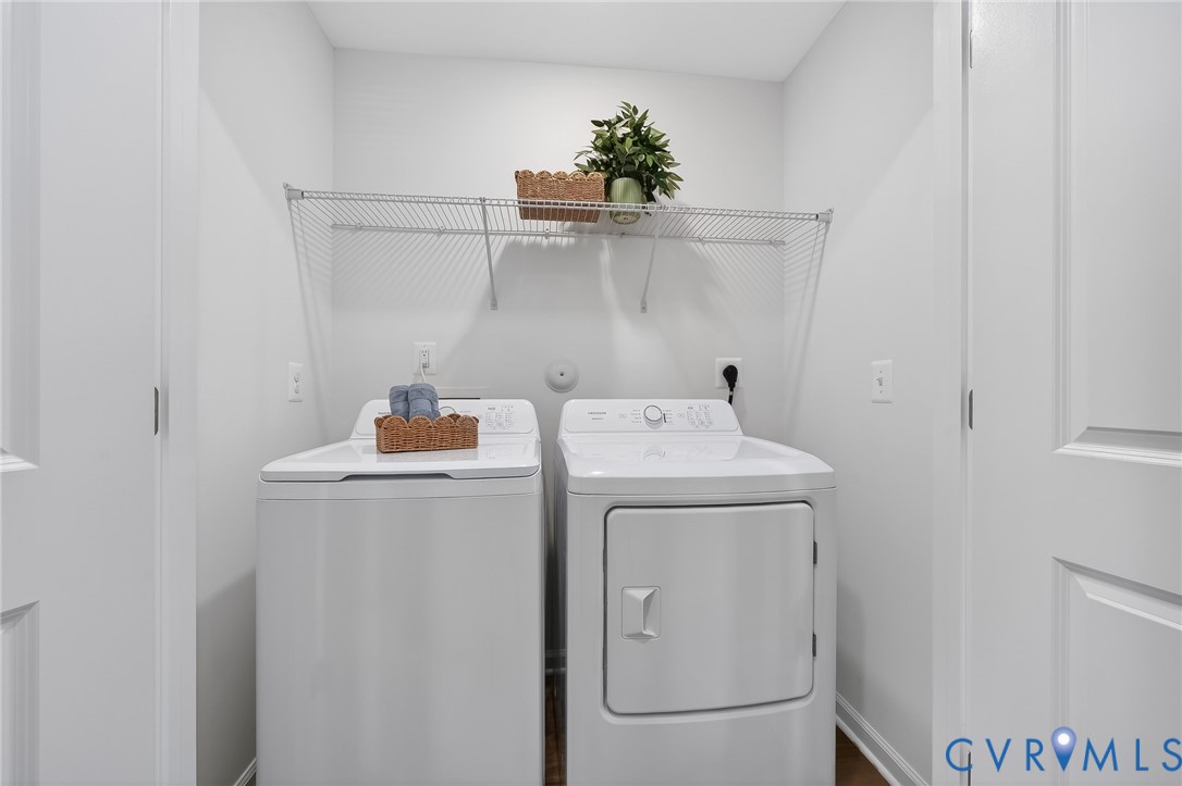 Dedicated laundry area featuring a top-load washing machine and a front-load dryer