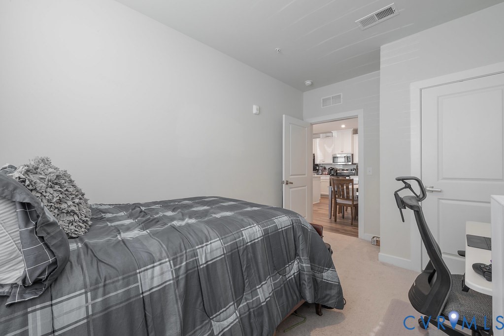 Light-colored walls with trim, white interior doors, and light-colored carpeting