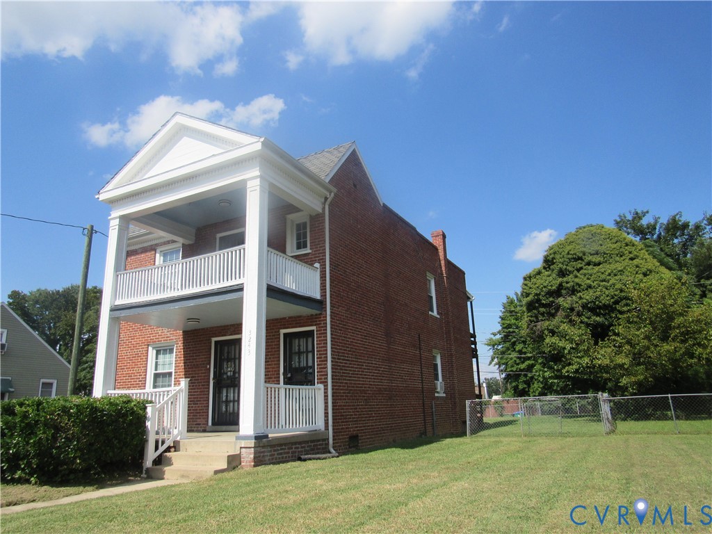 Brick exterior with a prominent two-story columned porch