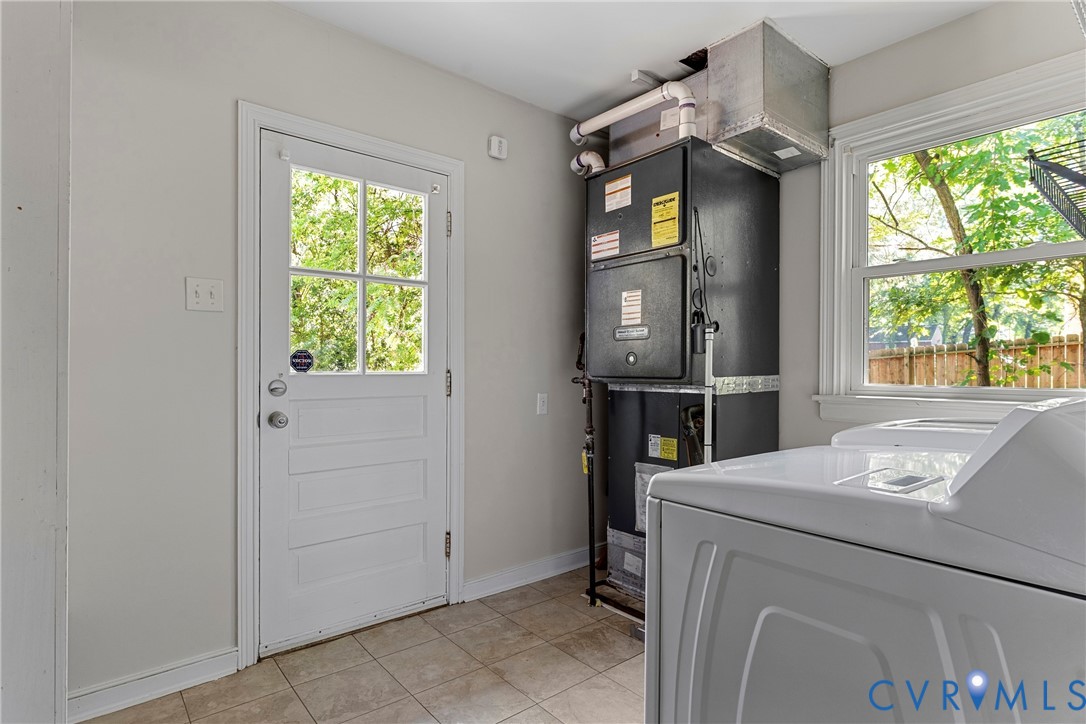 Utility area with a transom-style door, tiled flooring, and a single window