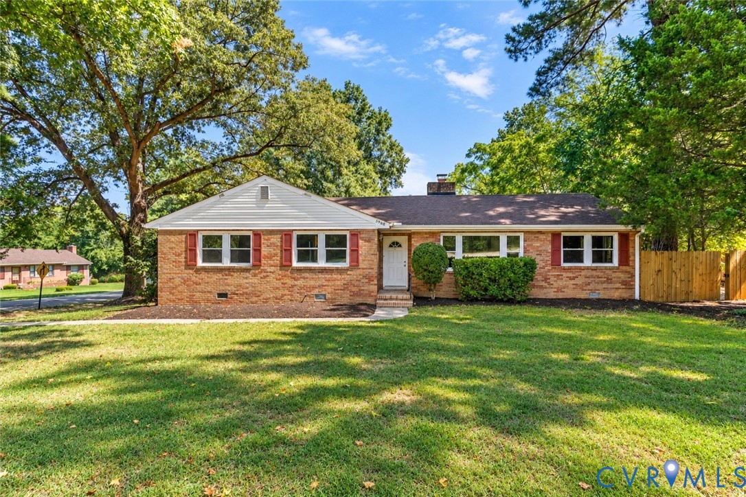 Brick exterior with red shutters, white trim, and a gabled roof