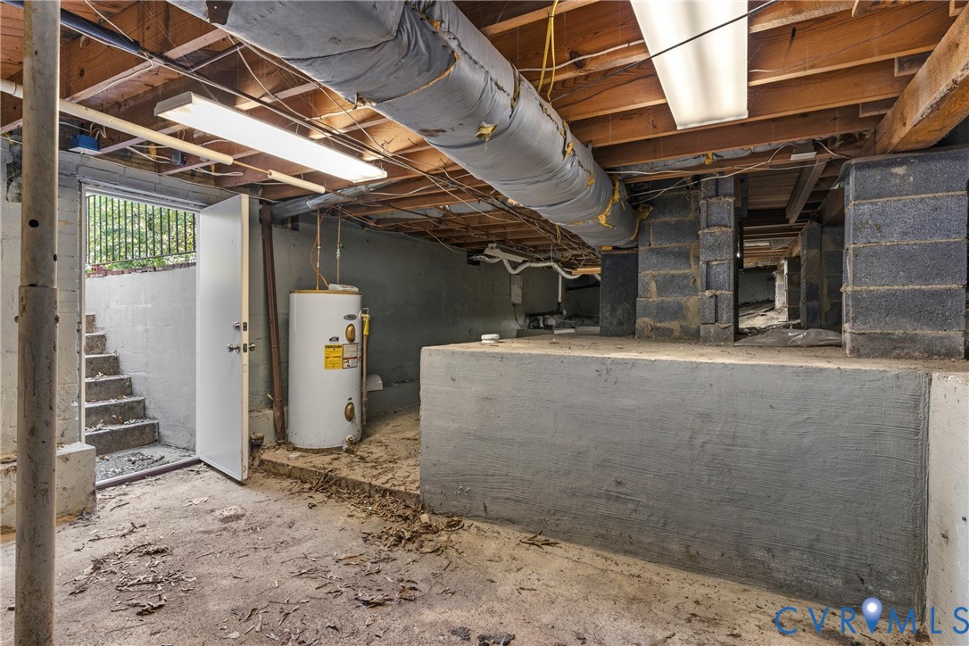 Crawl space foundation with exposed wood joists, structural block piers, and a visible water heater