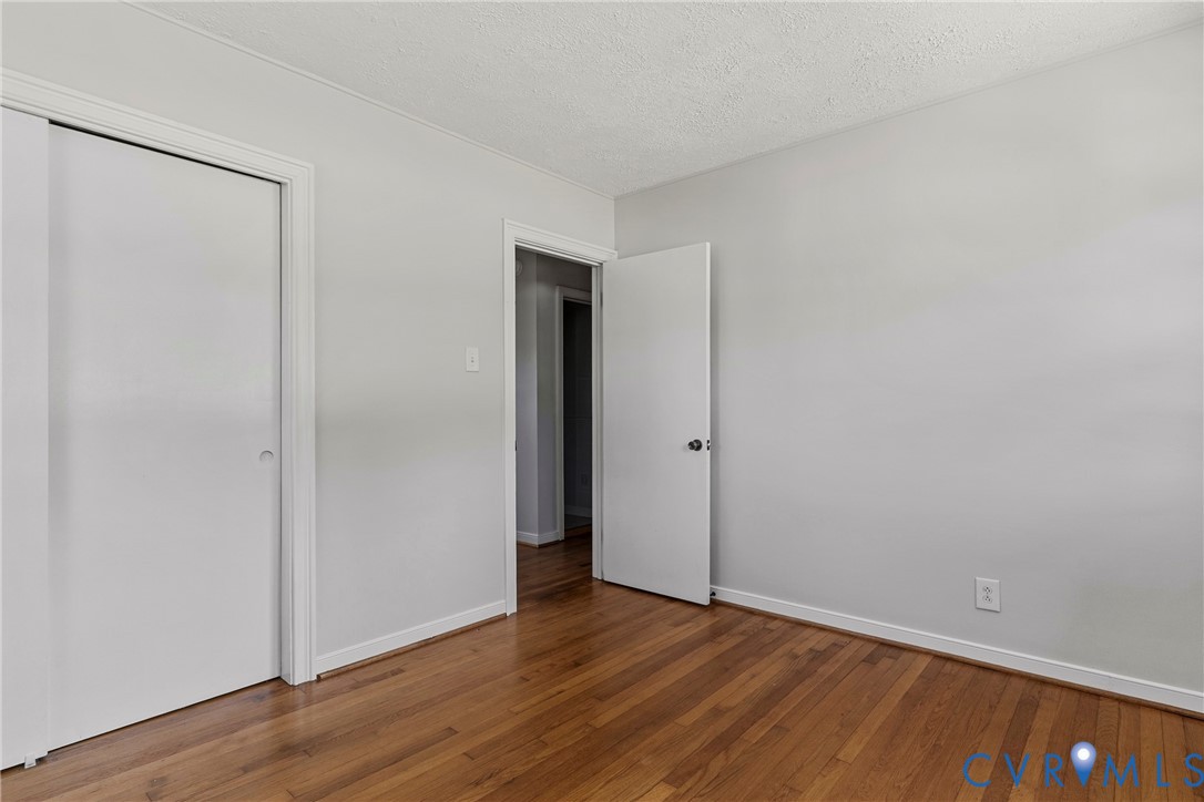 Wood-finish flooring with light-toned walls and white trim