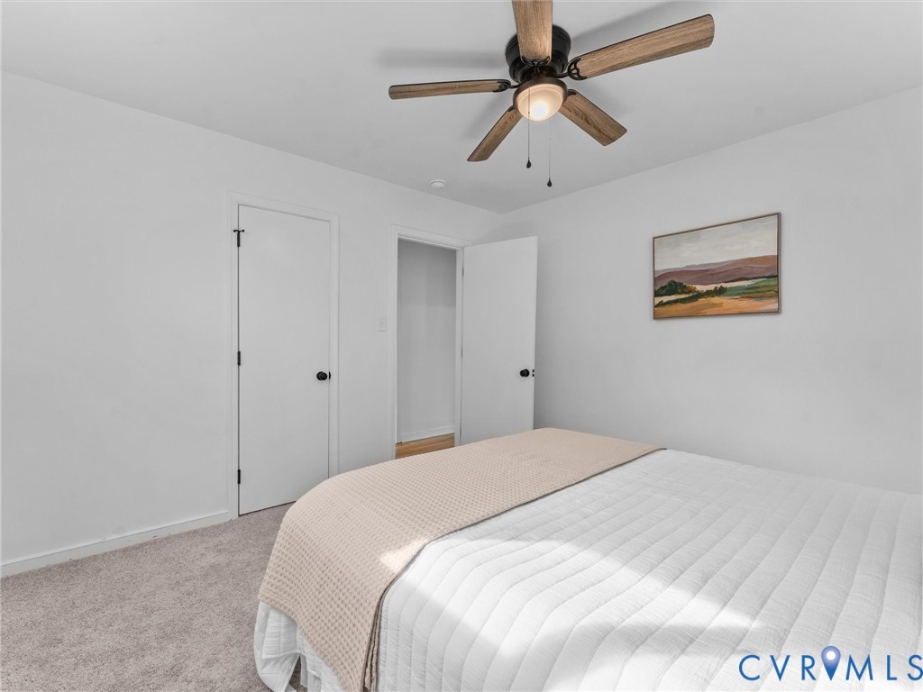 Recessed lighting, wood-finish ceiling fan, white paneled doors, and carpeted flooring