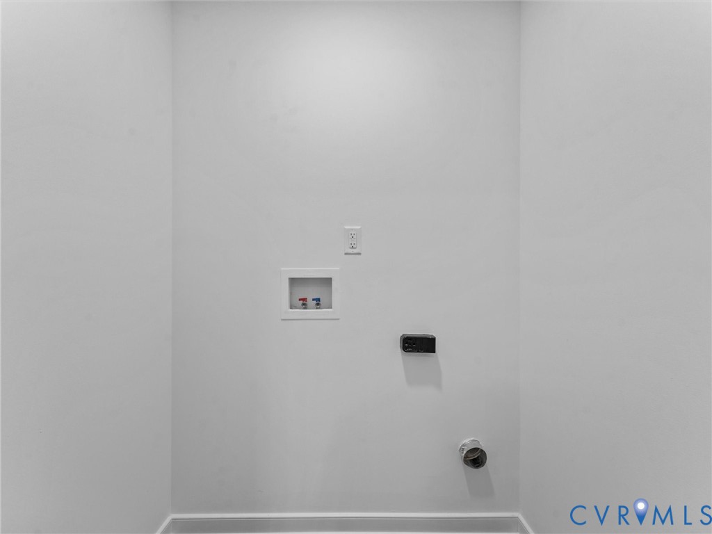 Dedicated laundry area with utility hookups and wall outlet