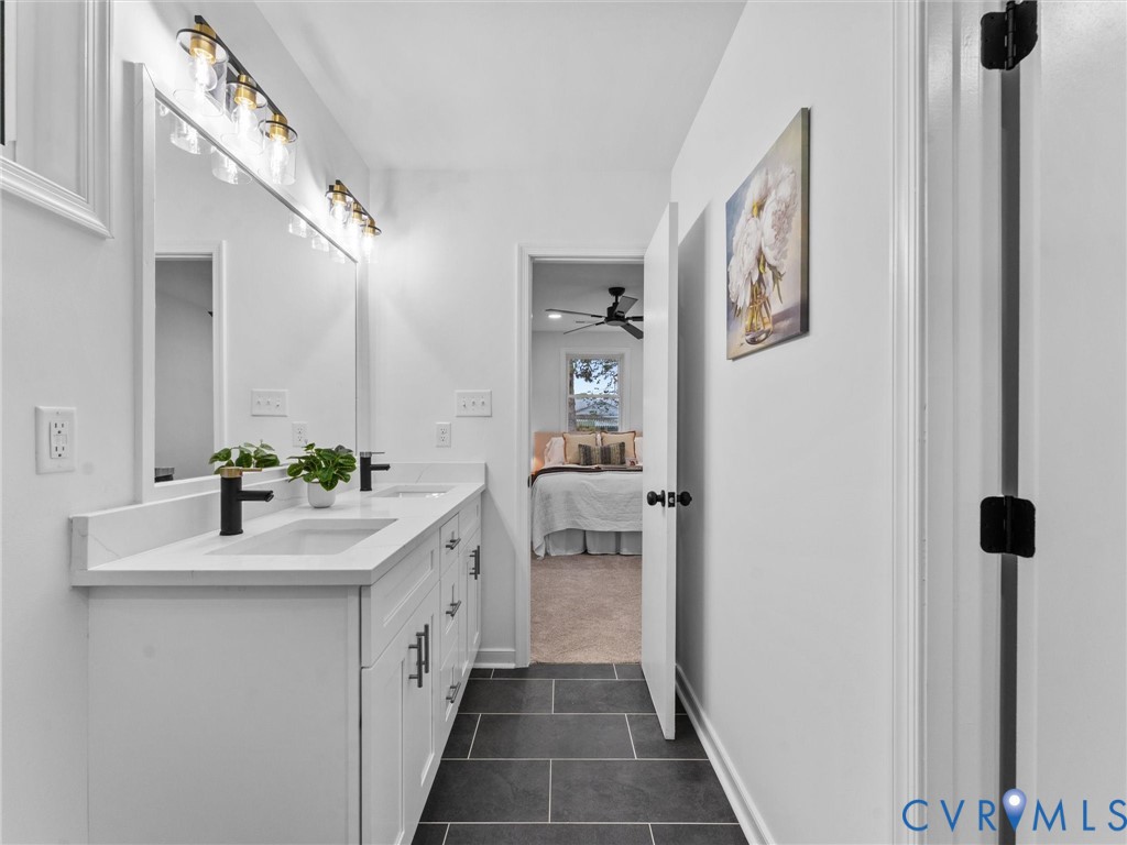 Dual vanity with white cabinetry, matte black hardware, and integrated sinks