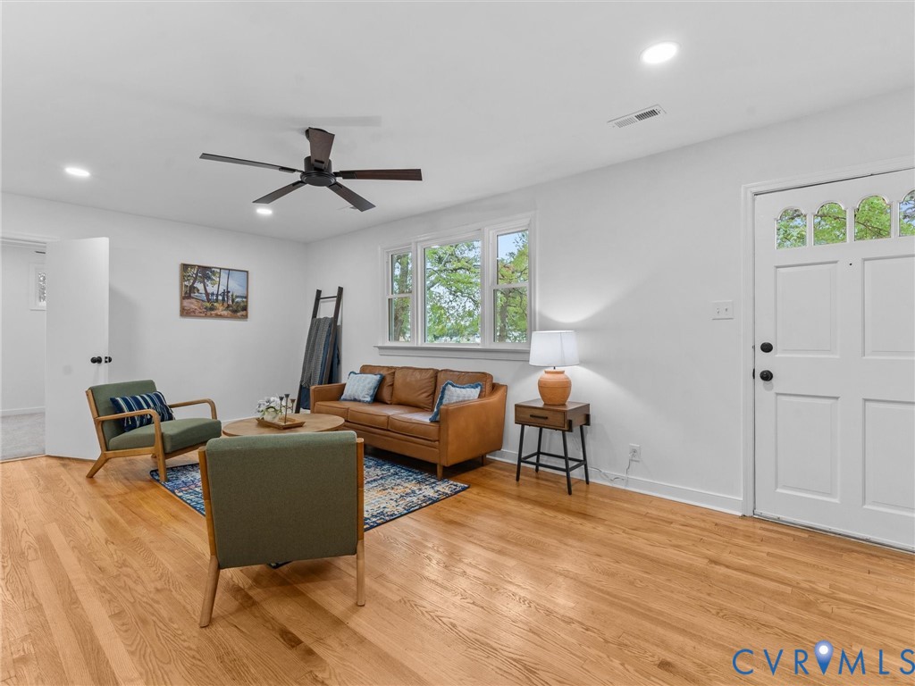 Hardwood flooring, recessed lighting, white walls, ceiling fan, and multi-pane front door Hardwood flooring, recessed lighting, white walls, ceiling fan, and multi-pane front door
