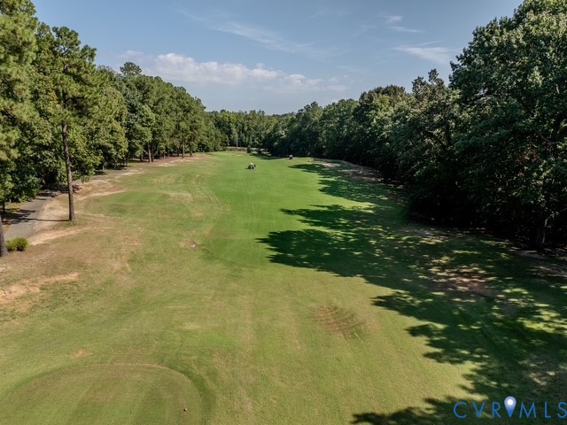 Expansive green space bordered by mature trees