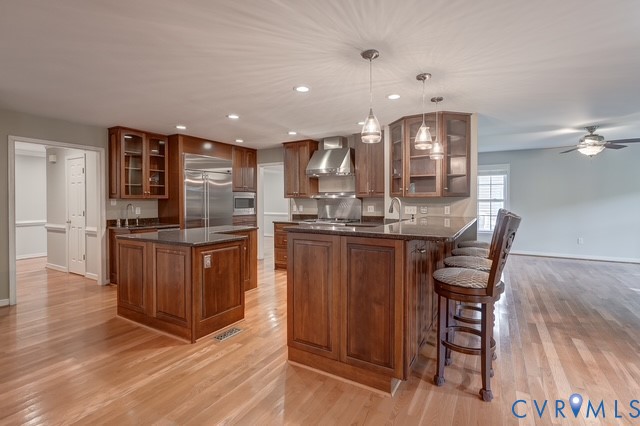 Chef's Kitchen featuring gas Wolf range, ice maker, beverage fridge, large island, pre sink and more!