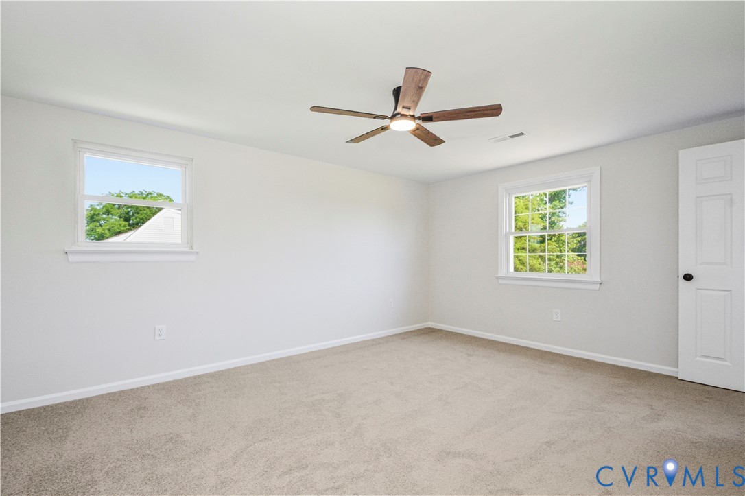 Neutral wall tones and plush carpet flooring