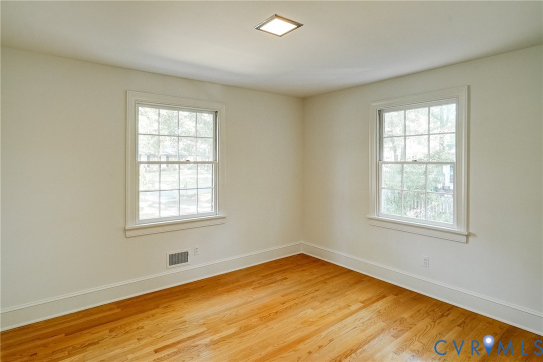 Bedroom #3 with hardwood flooring, closet and overhead lighting.