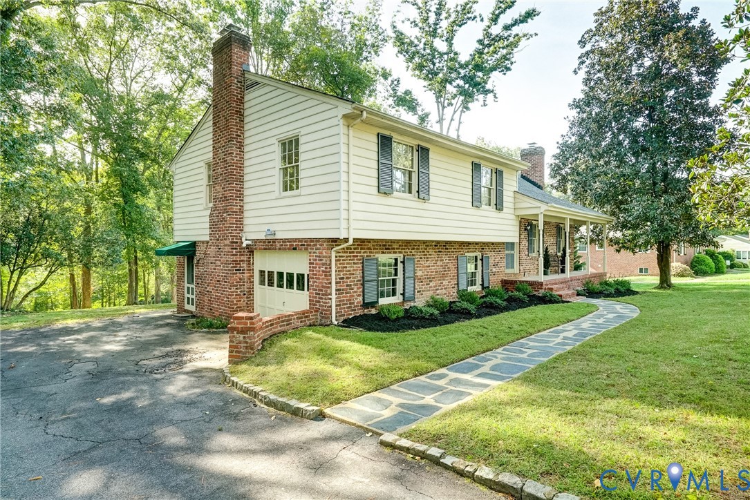 Low maintenance brick and vinyl exterior with one car garage