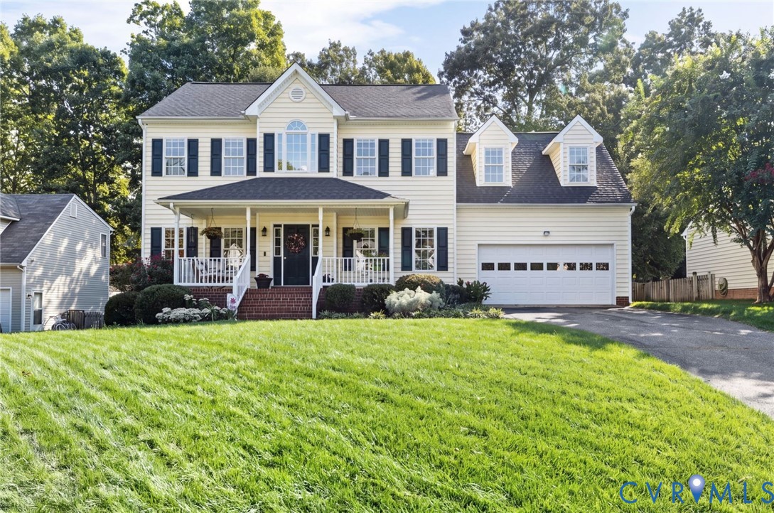 Classic colonial with gabled roofline, covered front porch, two-car garage with gabled dormers and a finished bonus room over the garage. Classic colonial with gabled roofline, covered front porch, two-car garage with gabled dormers and a finished bonus room over the garage.