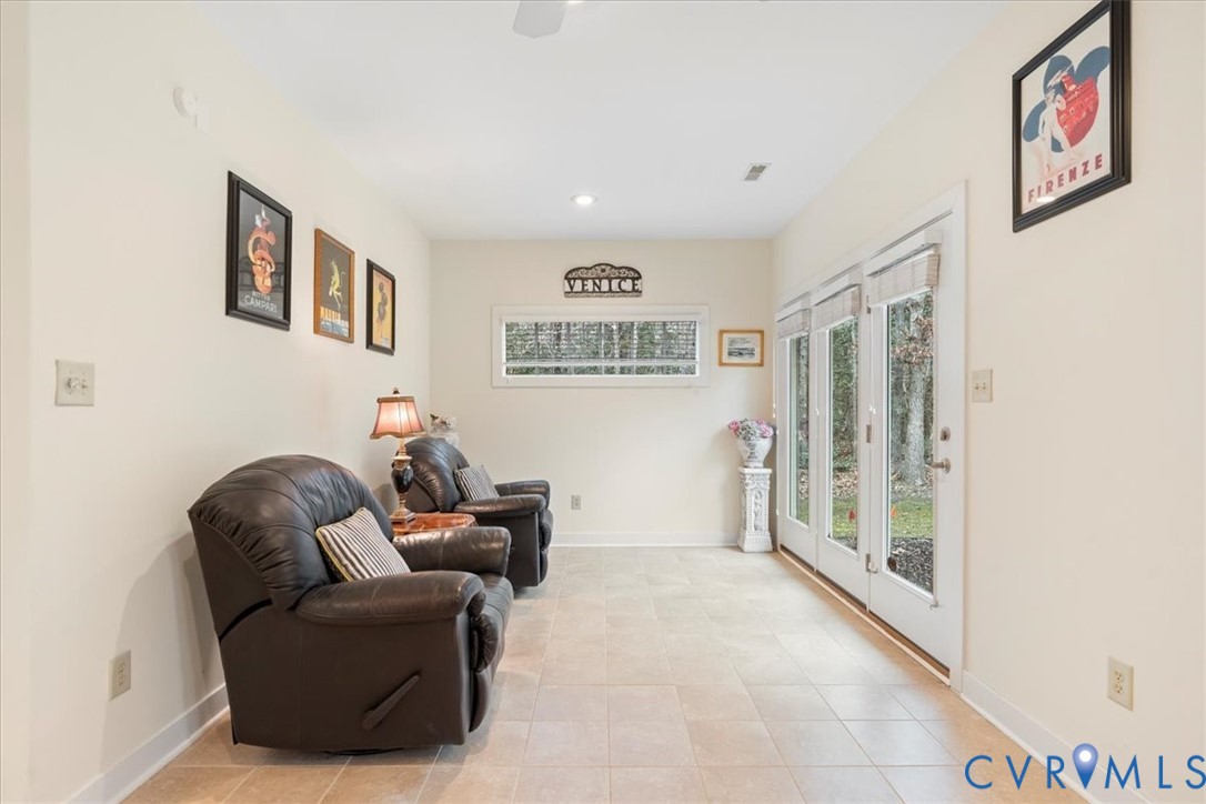Light-toned tile flooring, white walls, and a white ceiling create a bright interior