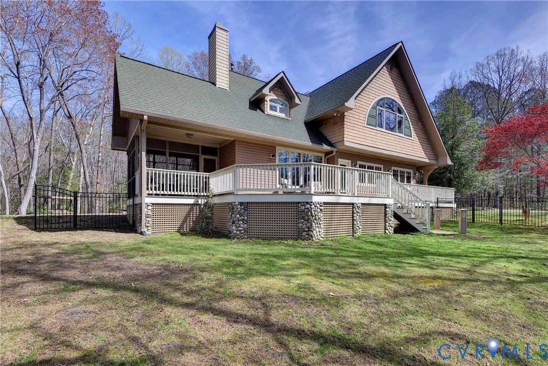 Multi-level exterior deck with a screened porch, lattice skirting, and stone column accents