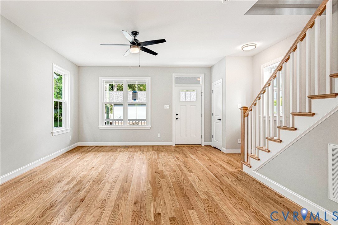 Hardwood flooring, painted white walls, white trim, recessed lighting, and a ceiling fan Hardwood flooring, painted white walls, white trim, recessed lighting, and a ceiling fan