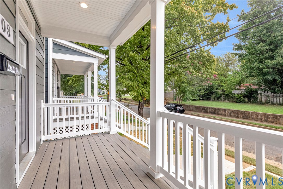 Inviting covered front porch with composite decking and white railing