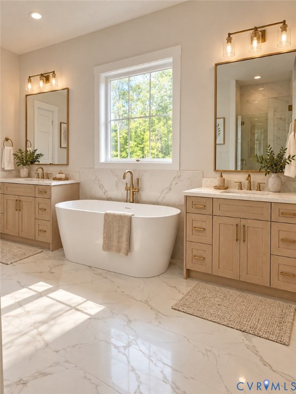 Freestanding soaking tub, dual wood-finish vanities with undermount sinks, bronze hardware, and large format tile flooring