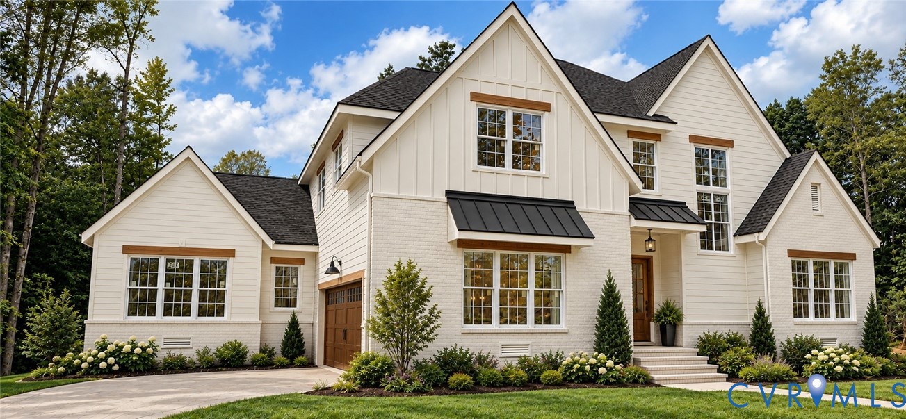 White brick and board-and-batten exterior with dark-toned roofing and a wood-finish garage door White brick and board-and-batten exterior with dark-toned roofing and a wood-finish garage door