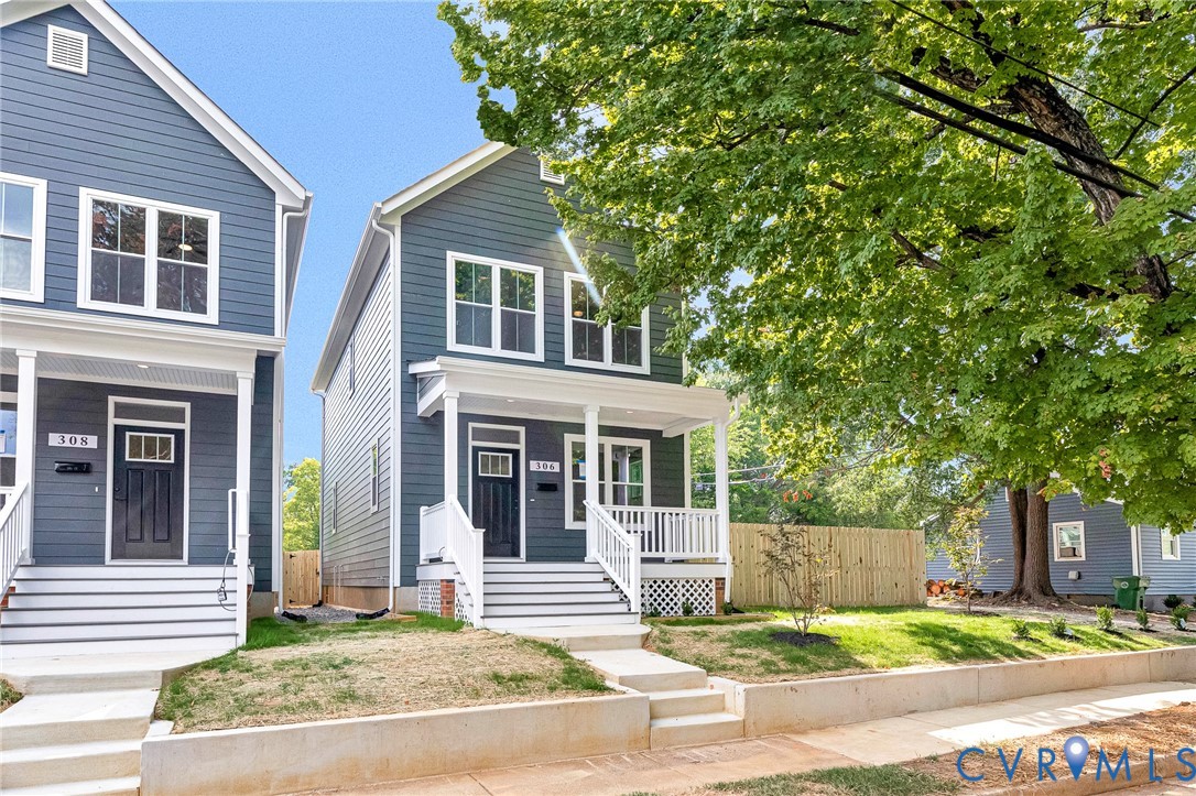 Modern facade with blue siding, white window trim, a covered porch, white railings, and a manicured front lawn Modern facade with blue siding, white window trim, a covered porch, white railings, and a manicured front lawn