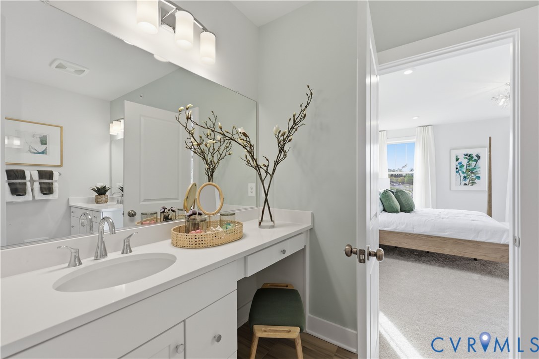 Bathroom vanity featuring a single undermount sink, brushed nickel faucet, and a large mirror