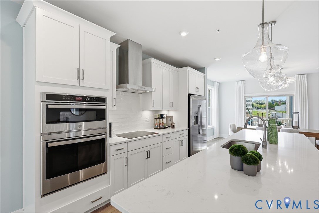 Kitchen featuring white shaker cabinetry, stainless steel appliances, and a built-in wall oven