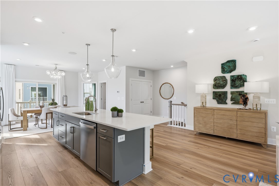 Spacious open-concept living area featuring wood-finish flooring