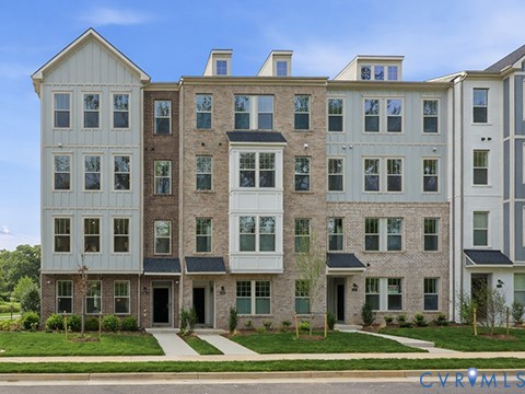 Contemporary multi-story townhomes featuring brick and vertical siding exteriors Contemporary multi-story townhomes featuring brick and vertical siding exteriors