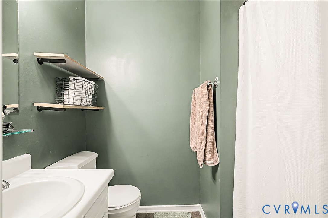White toilet and sink with a white vanity