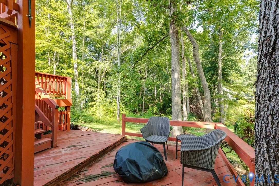 Expansive wood deck with a built-in privacy screen, wood railings, and a multi-level design