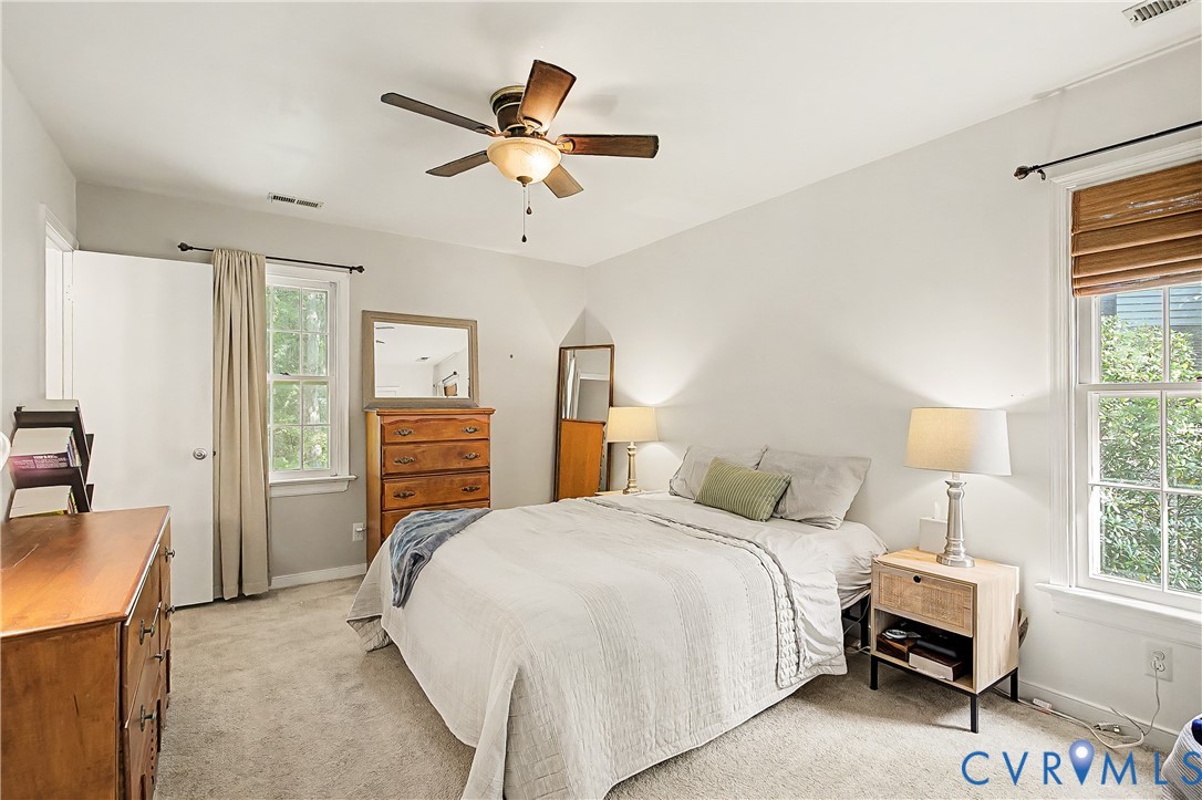 Recessed lighting, ceiling fan with integrated light, multiple windows, and light-toned carpeting