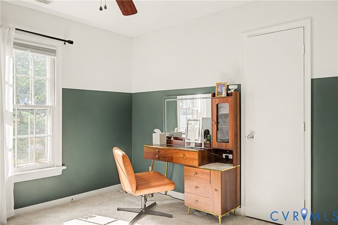 Window with white trim and a ceiling fan