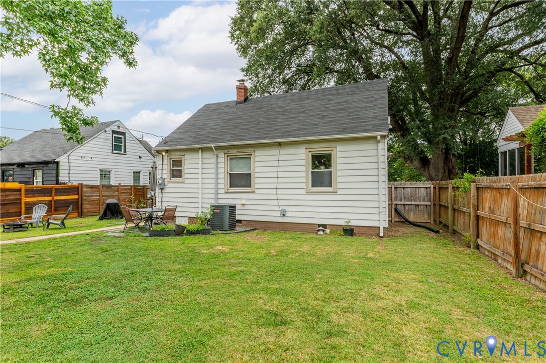 Expansive backyard with a flat lawn, featuring a patio area, and perimeter fencing