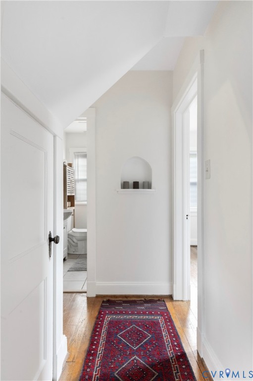 Hardwood flooring throughout, with a built-in wall niche, and white trim