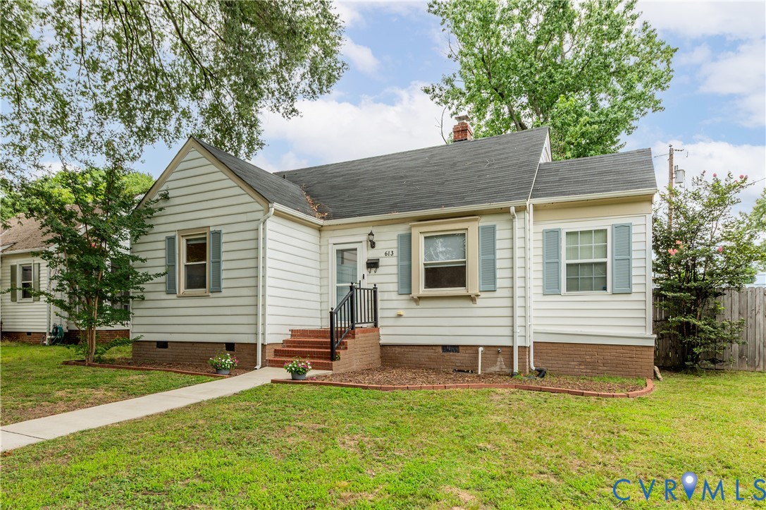 White siding exterior with brick foundation