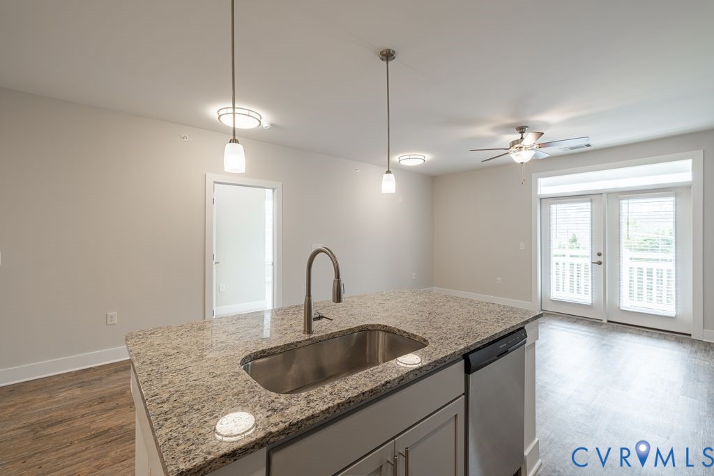 Kitchen island with a stainless steel sink and granite countertop