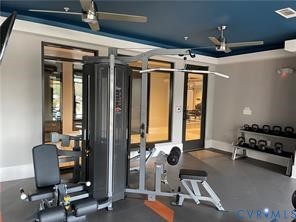 Fitness area featuring gray flooring, a multi-station weight machine, and a rack of kettlebells