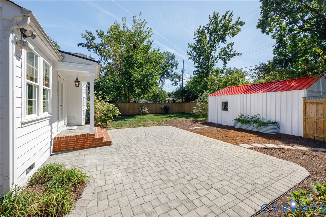 Expansive paver patio with a brick landing